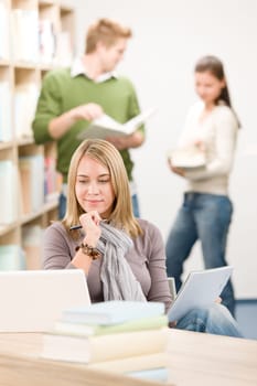High school library - thoughtful student with laptop