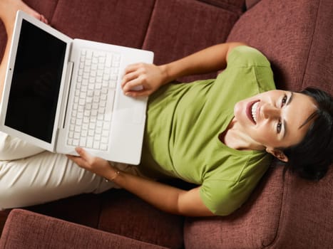 woman using laptop computer on sofa