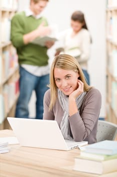 High school library - happy student with laptop