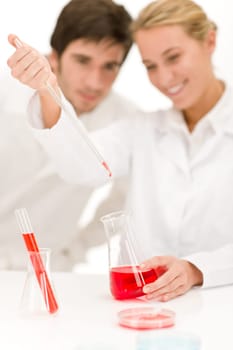 Scientists in laboratory - flu virus test tube