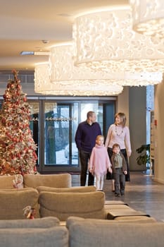 Happy family walking at foyer in the mod
