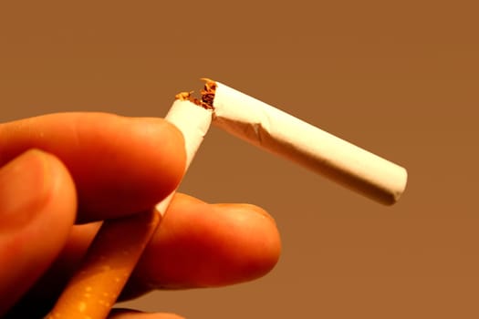 Broken cigarette in one hand