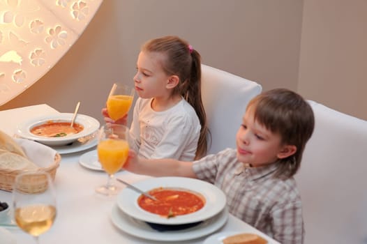 Sister and brother enjoying meal sitting