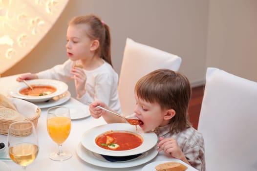 Sister and brother enjoying meal sitting