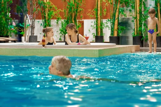 Happy attractive family relaxing by the