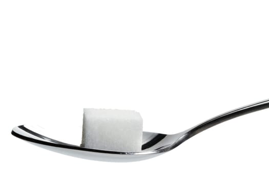 A sugar cube on a spoon