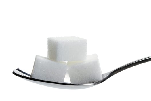 Three sugar cubes on a spoon