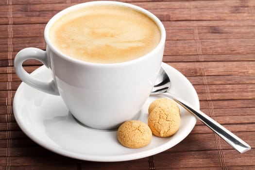 Coffee in white cup with amarettini