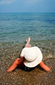 woman with hat on the beach