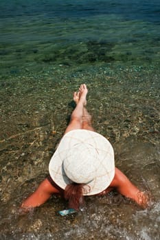 woman with hat on the beach
