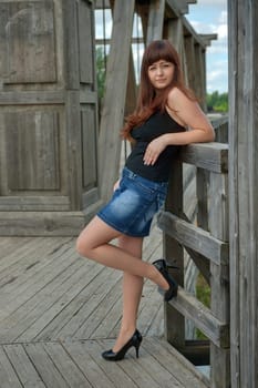 Young, sexy  woman in short skirt stand