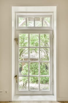 an open window in a room with wood floors and white trim on the windowsilling, there is a cat looking out