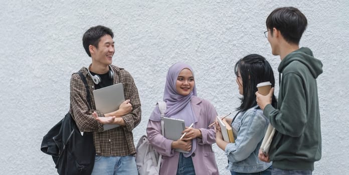 Outdoor of smiling university young group students college man and women students college smiling stand holding books and laptop computers on campus, Education concept, Back to college concept.