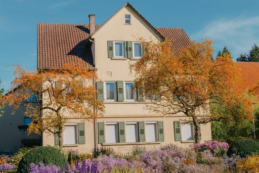 House with nice garden in fall. Flowers in the Park. Bietigheim-Bissingen. Germany, Europe. Autumn Park and house, nobody, bush and grenery