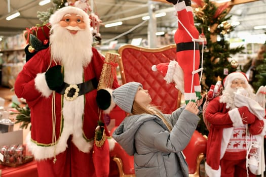 A child is surrounded by Santa Clauses in a shop
