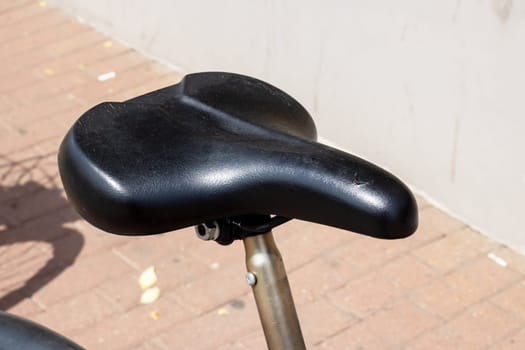 Saddle of bike on city background close up