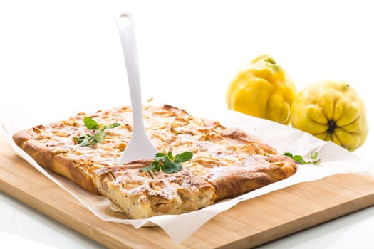 prepared curd semolina pie with quince inside and covered with powdered sugar isolated on white background.