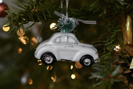 White car and toys hanging on a Christmas tree