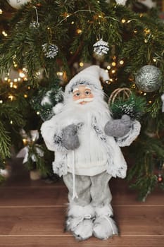 Christmas decorations Santa Claus standing under the Christmas tree