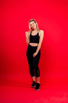 Beautiful young woman dressed in sports uniform, posing in the studio. Healthy lifestyle, sport