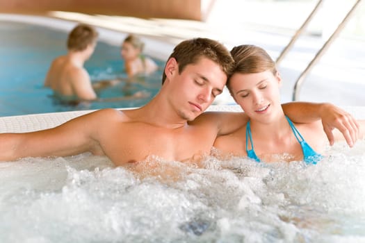 Swimming pool - young couple relax in hot tub