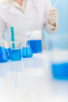 Woman scientist in laboratory chemical formula