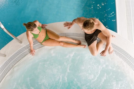 Top view - young couple relax in swimming pool