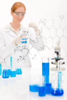 Woman scientist in laboratory chemical formula
