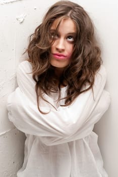 Young insane woman with straitjacket looking at camera close-up portrait