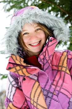 Happy winter girl in ski jacket