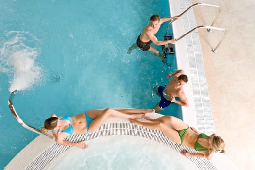 Top view - young people relax in swimming pool