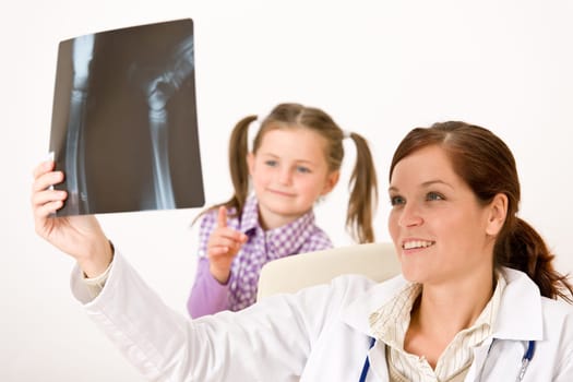Young female doctor show x-ray to child