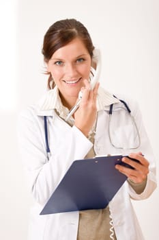 Female doctor on the phone with medical file
