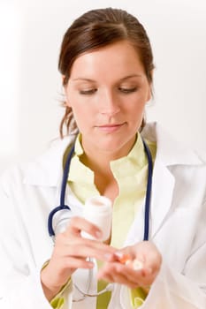 Female doctor with stetoscope holding tablet