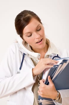 Female doctor on the phone with medical file