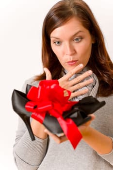 Surprised woman holding present shoes