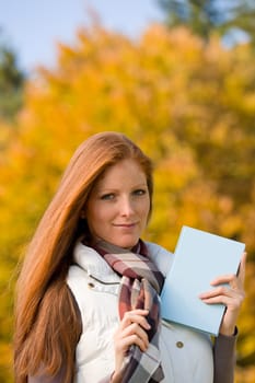 Autumn park - red hair woman with book