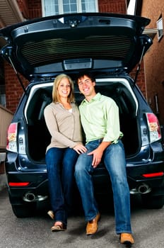 Couple sitting in back of car