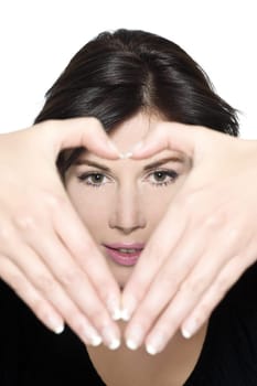 woman gesturing heart shape with hands portrait
