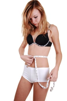 Girl measuring her belly.
