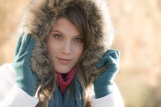 Winter fashion - woman with fur hood outdoors