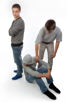 Two upset friends comforted by a third