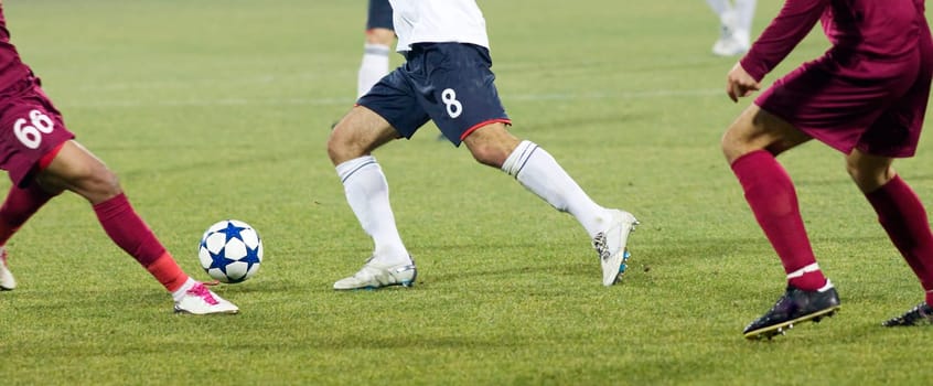 Soccer players fighting for the ball