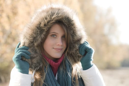 Winter fashion - woman with fur hood outside