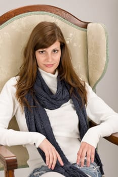 Fashion model posing on antique armchair