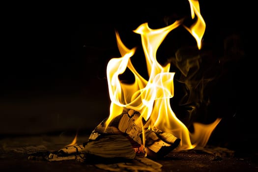 Close-up of a warm crackling fire with bright yellow flames.