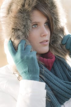Winter fashion - woman with fur hood outdoors
