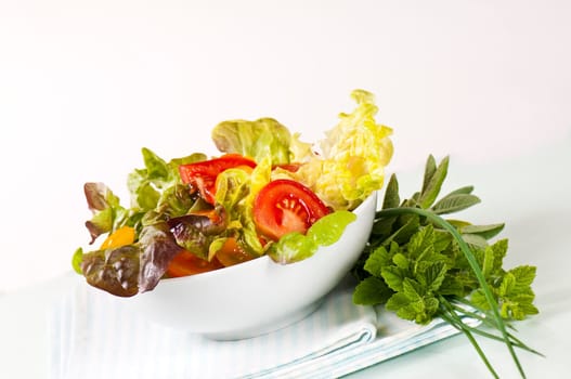Mixed salad in porcelain bowl
