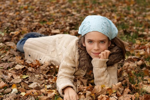 Girl in autumn leaves