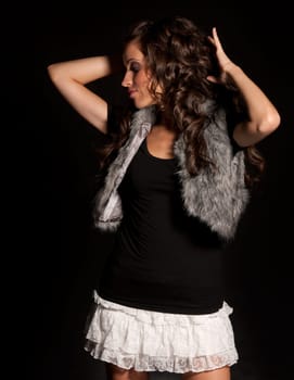 Young girl dancing at disco. Blue and purple background.